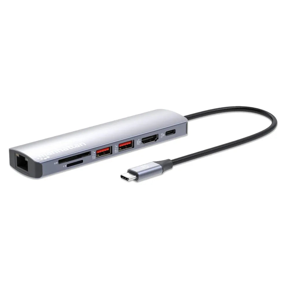 Manhattan USB-C 7-in-1 docking station with silver aluminium body, featuring HDMI ports, USB-A ports, SD card reader, Ethernet port and braided black USB-C cable attached