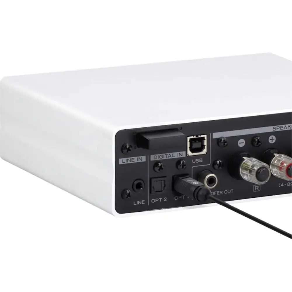 White and black audio amplifier with digital optical inputs, USB connection, and speaker outputs shown from rear angle view