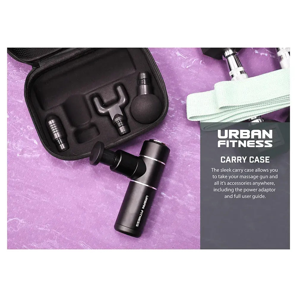 Urban Fitness Mini Massage Gun in black with carrying case, interchangeable heads and accessories displayed on purple background