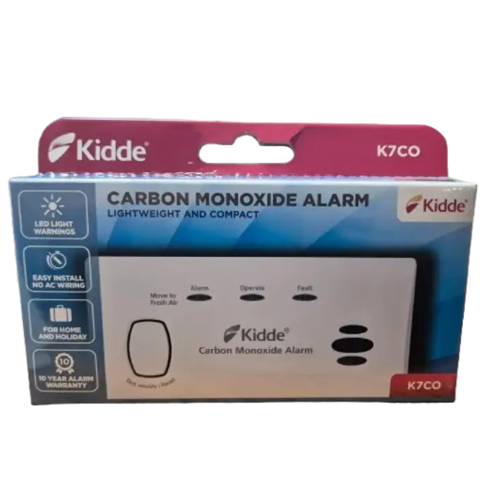 Kidde K7CO carbon monoxide alarm in packaging, white rectangular device with three black button controls labeled Alarm, Operate and Fault, displayed in burgundy and blue retail box with LED light warnings and 10-year warranty information