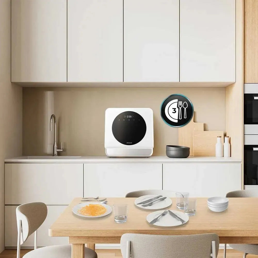 Cecotec Bolero Aguazero white compact countertop dishwasher displayed on a minimalist kitchen counter with wooden dining table, styled with place settings and kitchenware