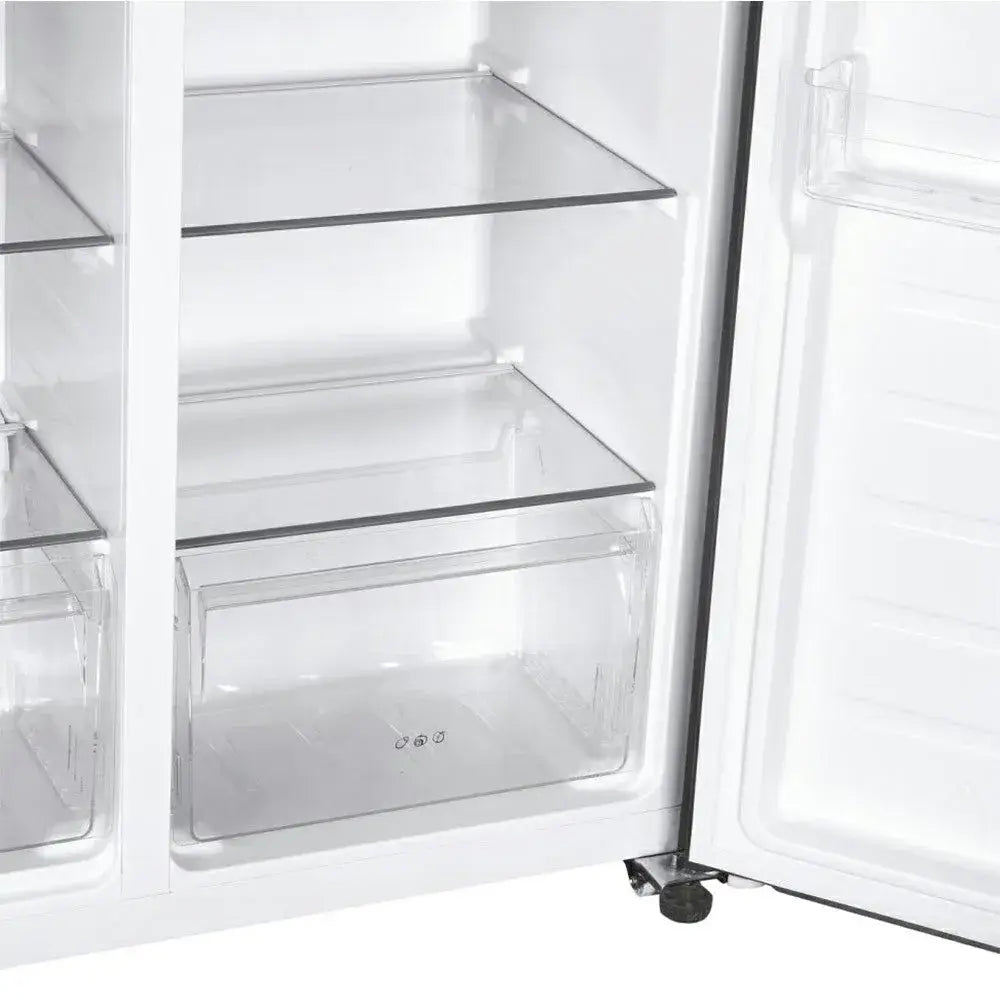 Interior view of Candy frost-free American fridge freezer showing empty white shelves with black trim, clear glass drawers, and stainless steel finish