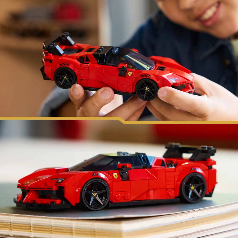 Child holding a red LEGO Ferrari SF90 XX Stradale sports car model above an assembled version displayed on a wooden surface, showcasing the buildable brick construction set from multiple angles