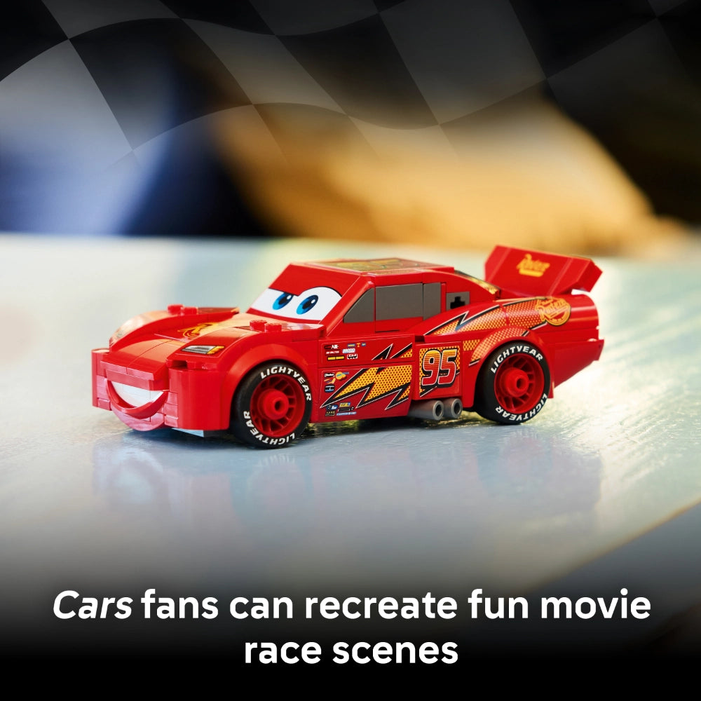 LEGO Lightning McQueen building set 77255 featuring red race car toy with number 95 and Lightyear branding on white surface with blurred background, ideal for recreating Cars movie scenes