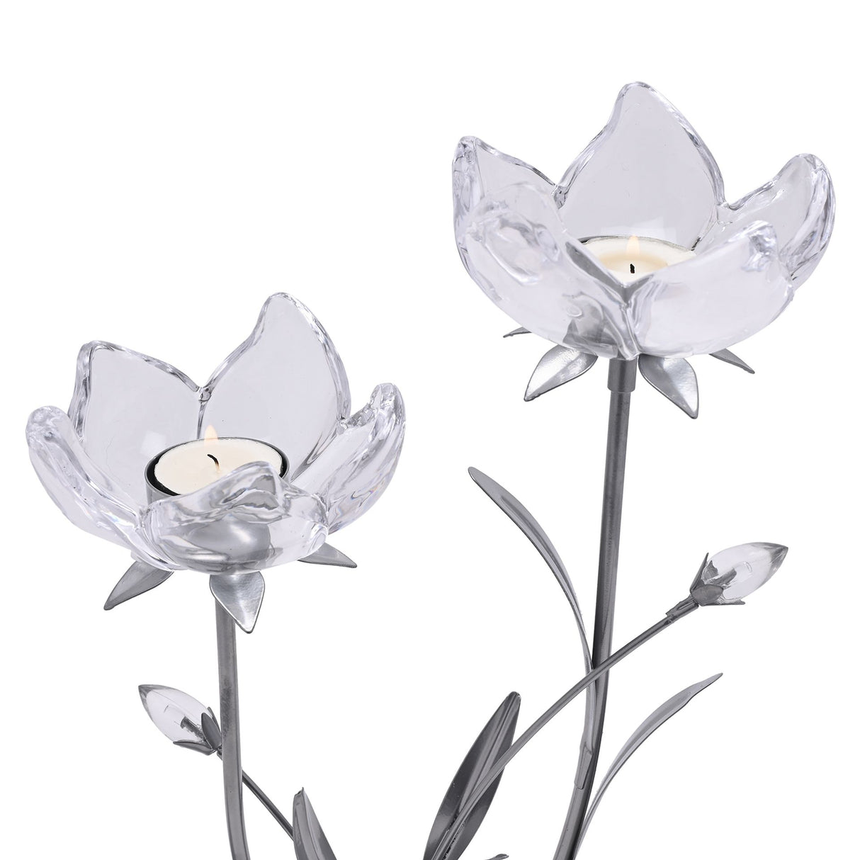 Two clear glass lotus flower candle holders with silver-toned stems and leaf details, each holding a cream-colored tea light candle, displayed against a white background