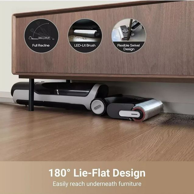 Dreame H14 Pro wet and dry vacuum cleaner with 180-degree lie-flat design shown in white and black, positioned under a wooden furniture piece on laminate flooring, with feature callouts highlighting full recline, LED-lit brush, and flexible swivel design