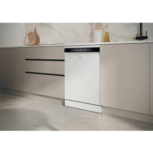 White Haier I Pro Shine Series 3 dishwasher integrated into beige kitchen cabinetry with marble backsplash and minimalist countertop styling
