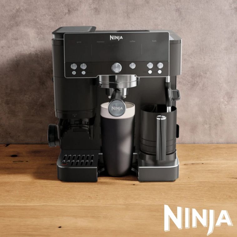 Ninja Luxe Café Premier Series black espresso machine with milk frother and cold brew function on wooden surface, featuring stainless steel portafilter and control panel with multiple buttons