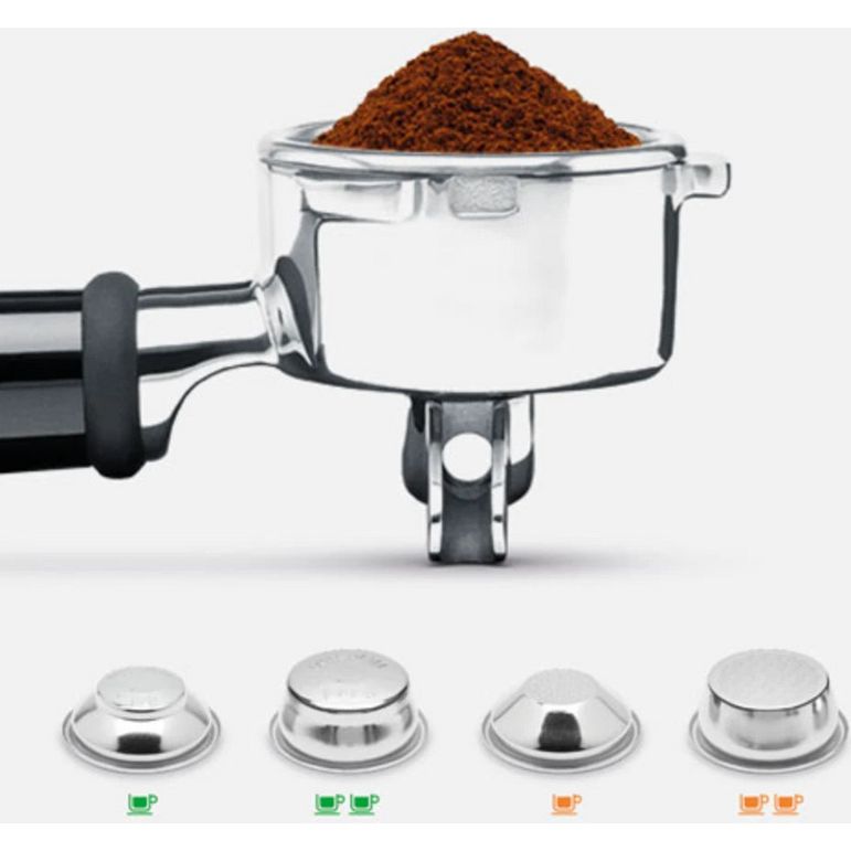 Sage Barista Express Impress coffee machine showing ground coffee in stainless steel portafilter with black handle, and four interchangeable shower head baskets below in silver metal with green and orange cup indicators for single and double shot options