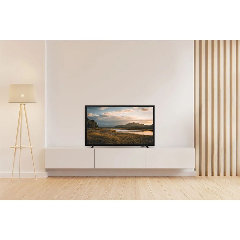 Samsung 32 inch HD LED smart TV mounted on white wall unit in minimalist living room with wooden flooring, beige tripod lamp and vertical blinds