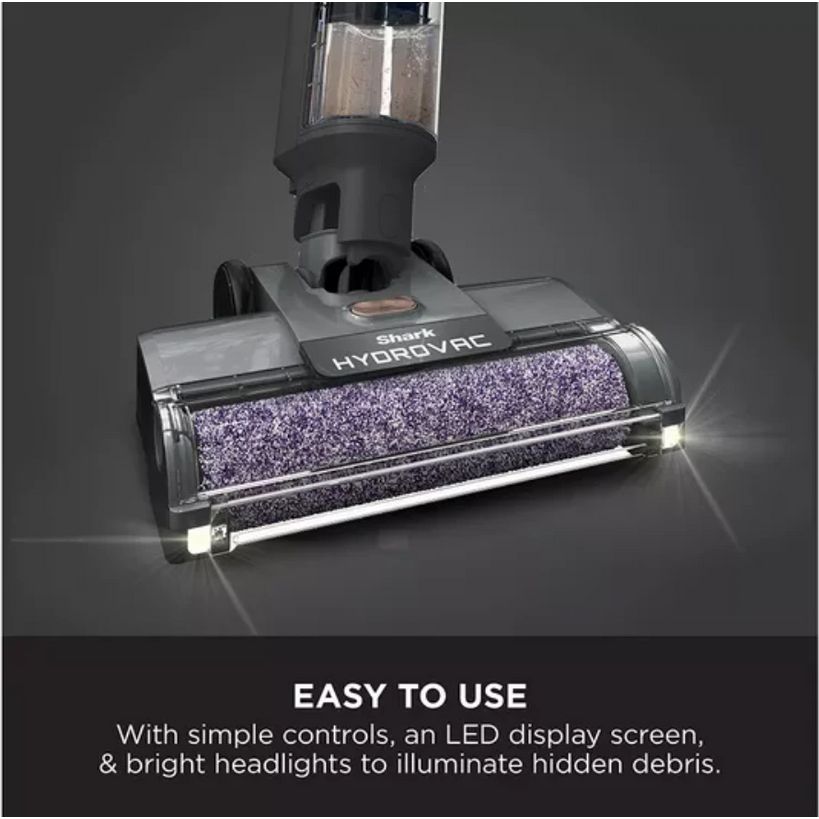 Shark HydroVac cordless vacuum cleaner with purple microfiber cleaning head, water tank attachment, LED headlights and simple controls displayed against dark gray background with easy to use product benefits text