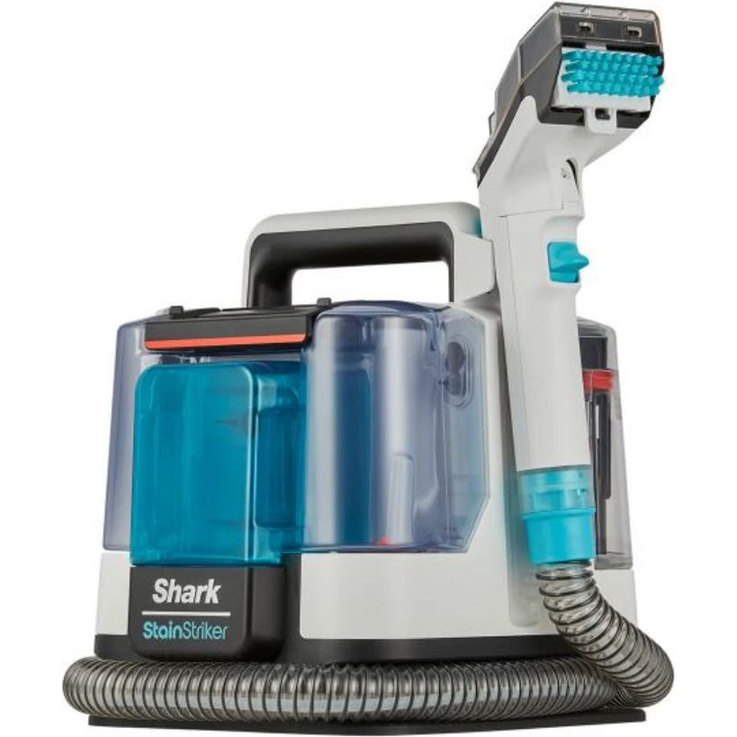 Shark StainStriker Pet Stain and Spot Cleaner machine with white and grey body, turquoise blue water tanks, heated brush head attachment on extendable hose, and black base with coiled suction tube