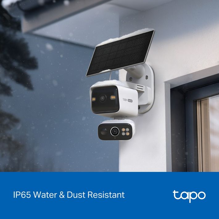 White TP-Link Tapo solar-powered dual lens security camera mounted on exterior wall with black camera lens, solar panel on top, and control panel below, IP65 water and dust resistant for outdoor surveillance