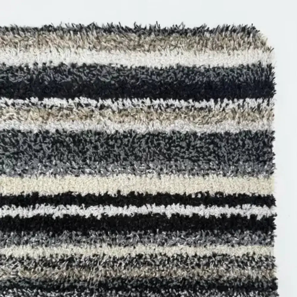 Hug Rug Candy Stripe doormat 50cm x 75cm featuring alternating horizontal stripes in black, white, grey and natural tones with textured loop pile surface