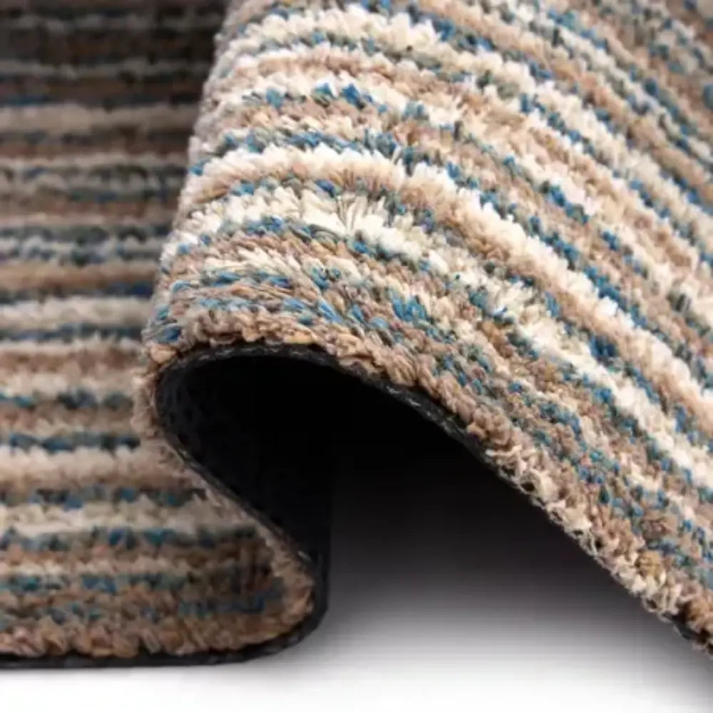 Hug Rug Doormat 80cm x 100cm in sand color with cream and blue striped pattern, showing rolled edge and dark rubber backing
