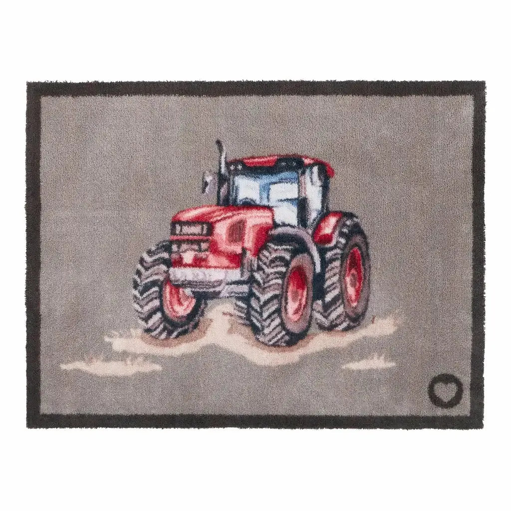 Hug Rug doormat featuring a red farmyard tractor with large black treaded wheels on a grey background, bordered by dark charcoal edging, 65cm x 85cm