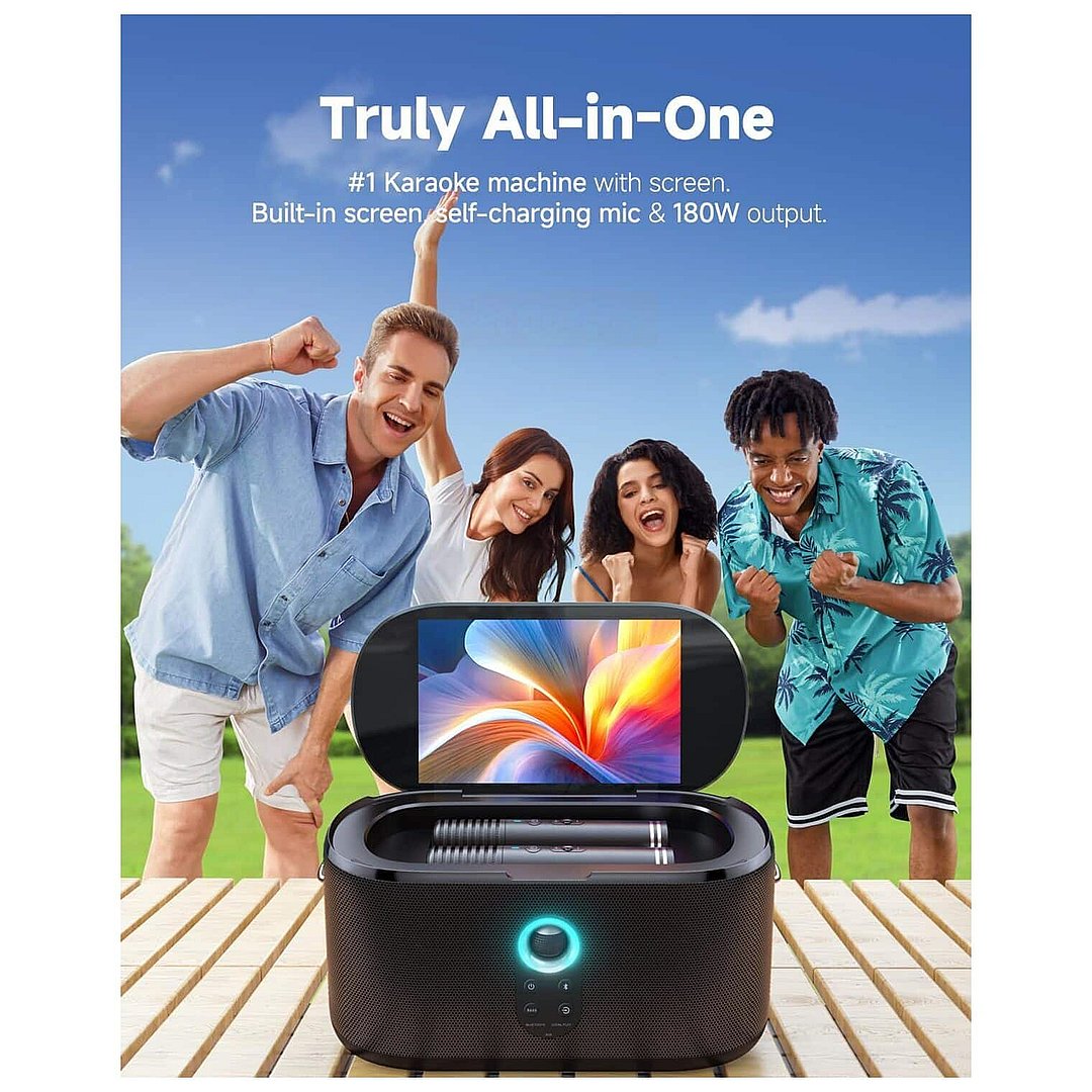 Ikarao Shell S1 portable karaoke machine with built-in 10.1 inch HD screen displaying colorful abstract graphics, two wireless microphones in storage compartment, dark textured finish with illuminated control button, surrounded by four happy people celebrating outdoors on wooden deck with green grass background