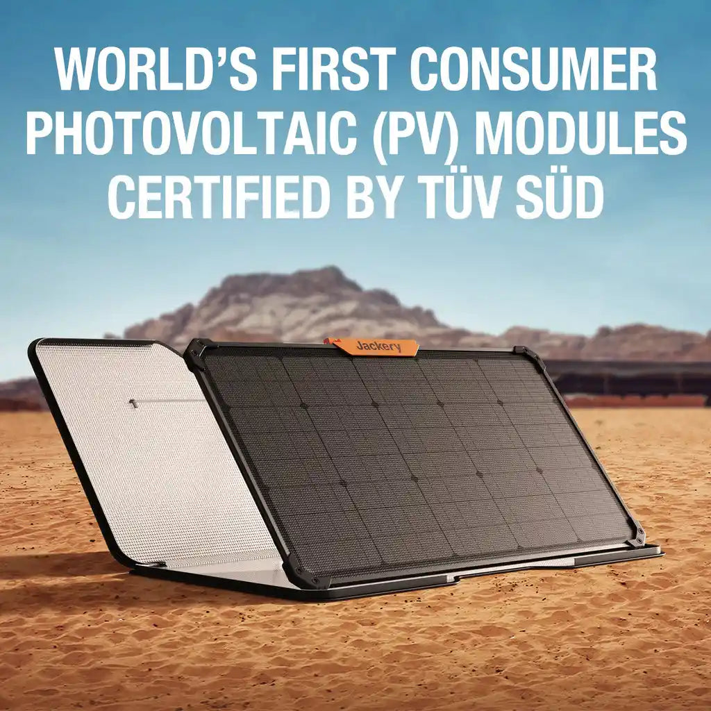 Jackery SolarSaga 80W portable solar panel displayed in desert landscape, showing black solar cells on right panel and white reflective surface on left panel with orange Jackery branding, certified consumer photovoltaic modules by TÜV SÜD