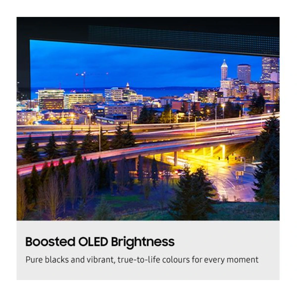 Samsung S85F 77 inch 4K OLED Smart TV displaying vibrant city skyline at dusk with illuminated buildings, highways with light trails, and blue evening sky demonstrating boosted OLED brightness and pure black levels