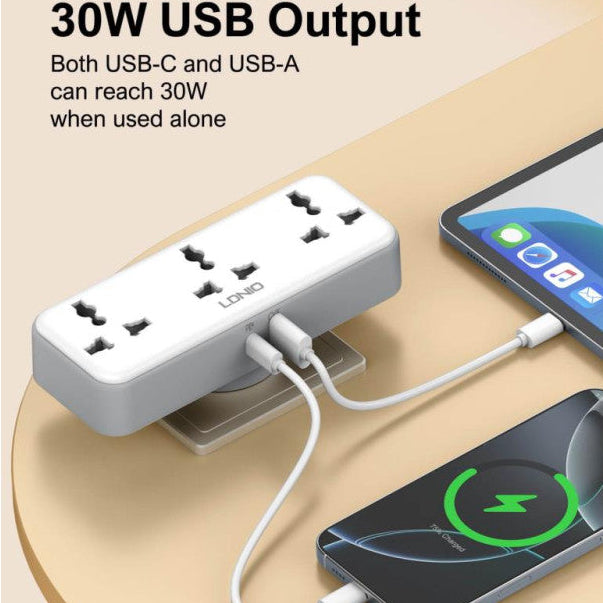 Power strip with multiple USB ports charging two smartphones on a beige surface.