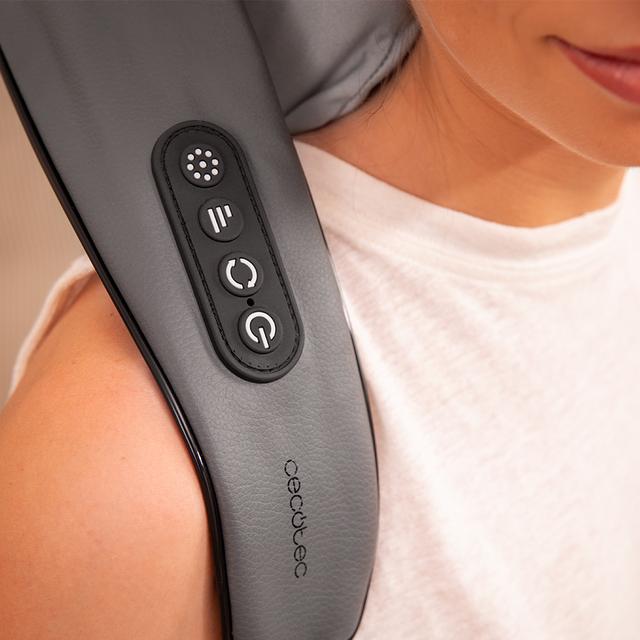 Woman using a neck and shoulder massager in a home setting