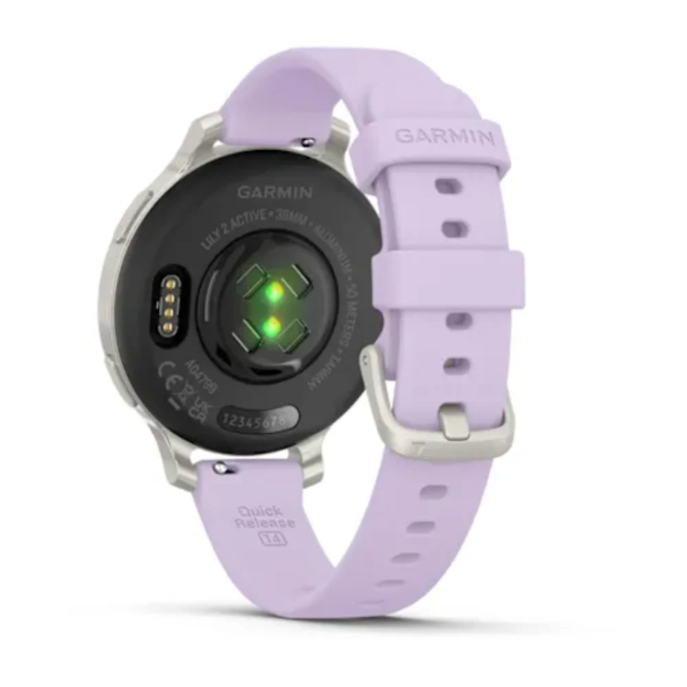 Garmin Lily 2 Active 38mm smartwatch with silver case, lavender purple silicone band, black dial with green heart rate sensor display and quick release strap detail visible from front angle