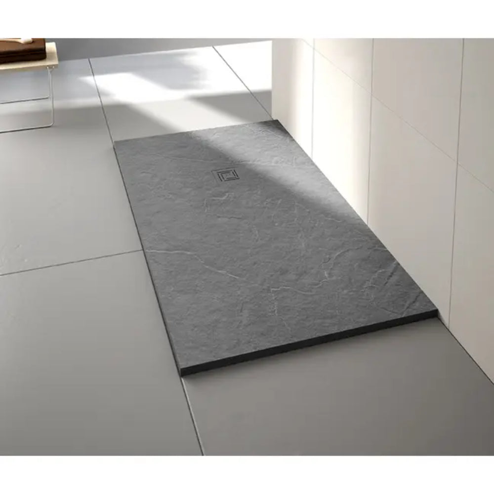 Modern gray slate effect rectangular shower tray with integrated drain installed in contemporary white tiled bathroom