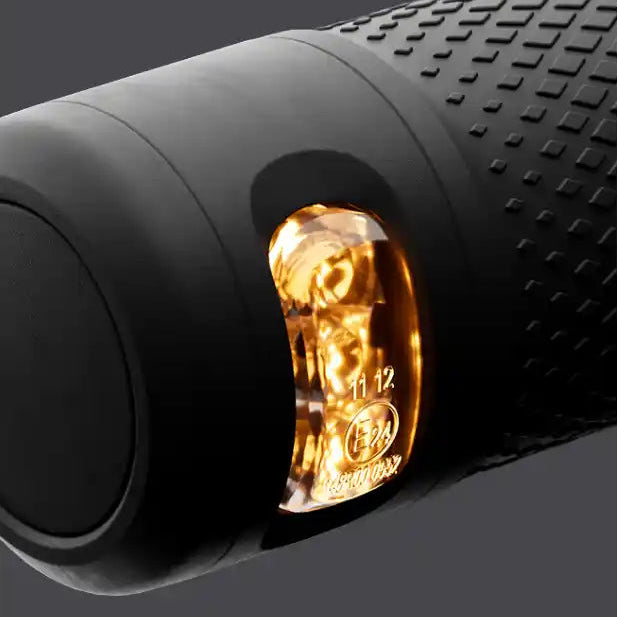 Close-up of illuminated amber rear light on black Segway Ninebot Kickscooter E3 Pro electric scooter showing textured grip surface and product branding