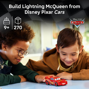 Two children building a red Lightning McQueen LEGO set with 270 pieces, recommended for ages 9 and up, from Disney Pixar Cars collection