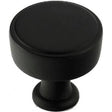Black round cabinet knob with pedestal base, modern minimalist design for kitchen doors and drawers
