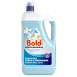 Bold Professional Lotus Flower and Water Lily laundry detergent bottle, 4.95 litre size, with light blue liquid inside clear plastic container, navy blue cap and label featuring white lotus flower illustrations and red Bold branding, marketing text highlighting clean and freshness benefits and 110 wash count