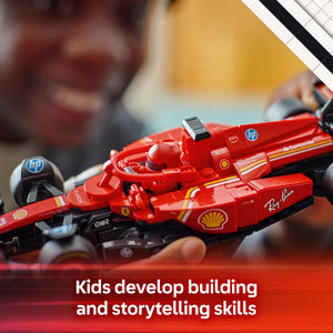 Red LEGO Ferrari SF-24 Formula 1 race car model with Shell and Ray-Ban branding displayed on a red surface with building instructions visible in background, demonstrating kids building and storytelling skills