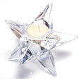Clear glass star-shaped tealight candle holder with white tealight candle, Newgrange Living design, isolated on white background