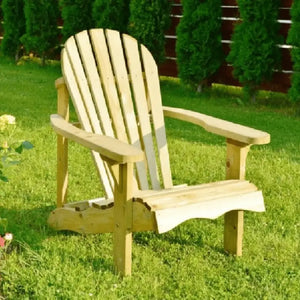 Pressure treated wooden Adirondack chair with natural light wood finish, vertical slat back design and wide armrests, positioned on green lawn with evergreen trees and garden shrubs in background
