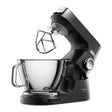 Kenwood Titanium Chef Baker 1200W stand mixer in black with stainless steel bowl, flat mixing paddle and whisk attachment shown against white background