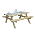 Pressure treated wooden picnic bench table with natural light wood finish, featuring integrated benches on both sides, set table with white dinnerware, glasses and centerpiece decorations