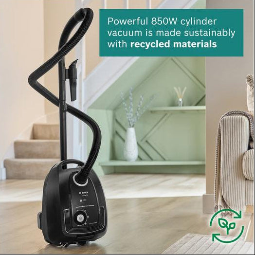 Bosch vacuum cleaner with text about sustainability on a wooden floor.