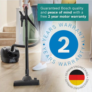 Person using a vacuum cleaner on a wooden floor with a Bosch warranty badge displayed.