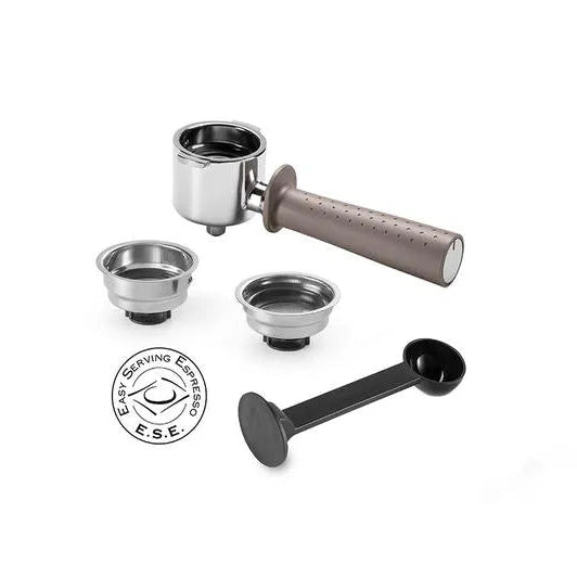 DeLonghi Stilosa espresso machine accessories kit showing chrome portafilter with wooden handle, two stainless steel filter baskets, black tamper, and ESE pod logo on white background