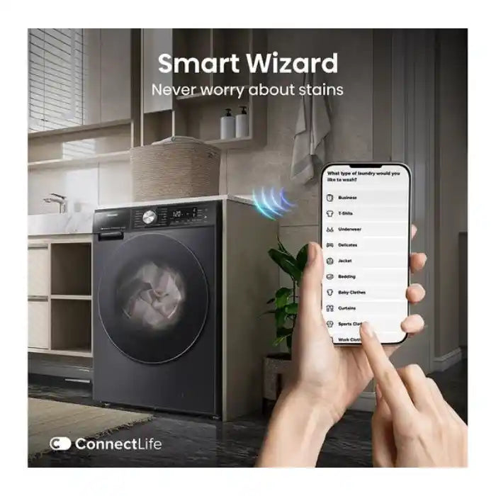 Smart Wizard laundry management app displayed on smartphone showing laundry type selection options connected to black Hisense WD5S1045BB washer dryer with auto dosing technology in modern kitchen setting with white cabinetry and potted plant
