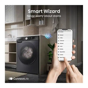 Smart Wizard laundry management app displayed on smartphone showing laundry type selection options connected to black Hisense WD5S1045BB washer dryer with auto dosing technology in modern kitchen setting with white cabinetry and potted plant
