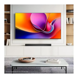 Hisense A6Q 65 inch 4K Smart TV mounted on white wall unit with wooden shelving displaying vibrant colorful abstract wallpaper on screen, black soundbar below, white coffee table with wooden bowl and books in modern living room setting