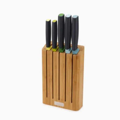 Joseph Joseph Elevate knife block set with five knives featuring black handles and colored accents in yellow, green and blue, displayed in a natural bamboo wooden block holder