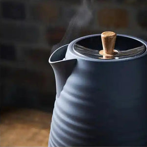 Morphy Richards Clay Flint grey jug kettle with wooden handle lid knob, steam rising from spout, textured ceramic body, 1.7 litre capacity