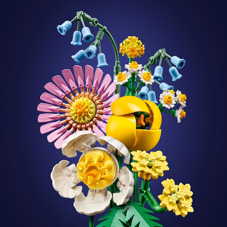 LEGO Petite Sunny Bouquet set 10347 featuring colorful buildable flowers including pink daisy, white bloom, yellow chrysanthemum and bell flowers with green stems and leaves against dark blue background