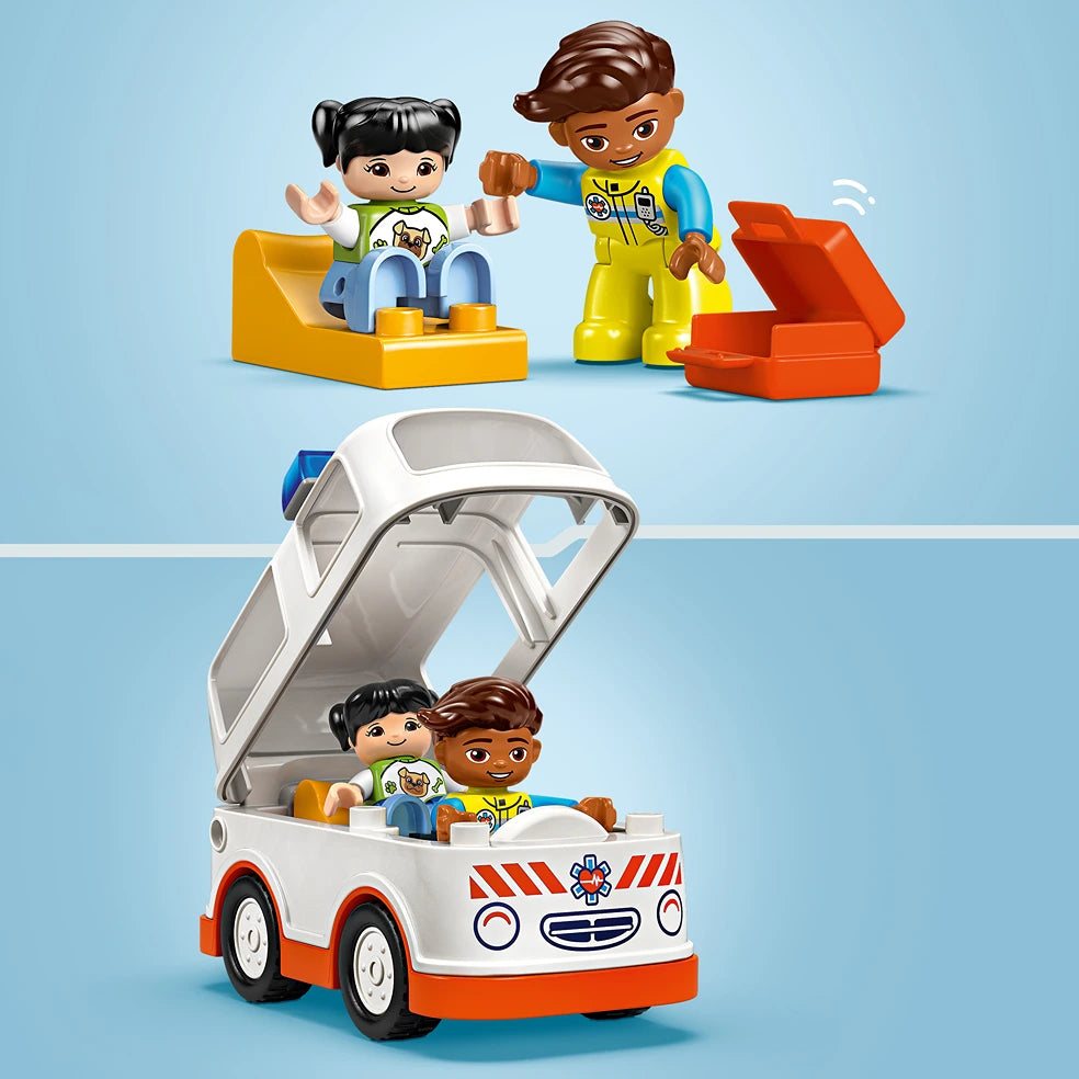 LEGO Duplo ambulance set featuring a white and red toy ambulance with opening canopy, two diverse DUPLO figures in medical attire, and colorful building blocks on light blue background