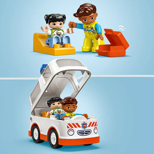 LEGO Duplo ambulance set featuring a white and red toy ambulance with opening canopy, two diverse DUPLO figures in medical attire, and colorful building blocks on light blue background