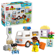 LEGO Duplo Ambulance and Driver set 10497 featuring white and orange ambulance vehicle with blue roof, two minifigures in yellow and blue outfits, traffic light, medical supplies, and colorful building blocks on green base, 19 pieces for ages 2 and up