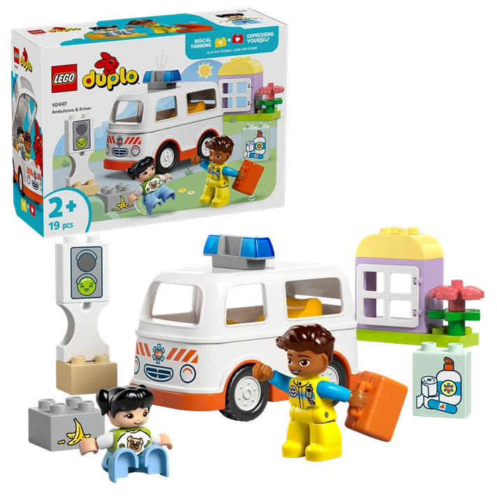 LEGO Duplo Ambulance and Driver set 10497 featuring white and orange ambulance vehicle with blue roof, two minifigures in yellow and blue outfits, traffic light, medical supplies, and colorful building blocks on green base, 19 pieces for ages 2 and up