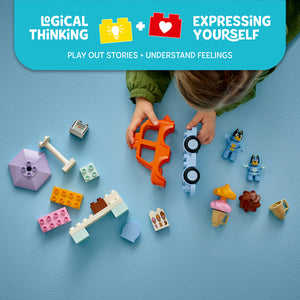 Child's hands assembling colorful LEGO bricks including orange connectors, pink and yellow building blocks, blue minifigures of Bluey characters, ice cream elements, and a white vehicle with black wheels on a turquoise background, with messaging about logical thinking and expressing yourself through play